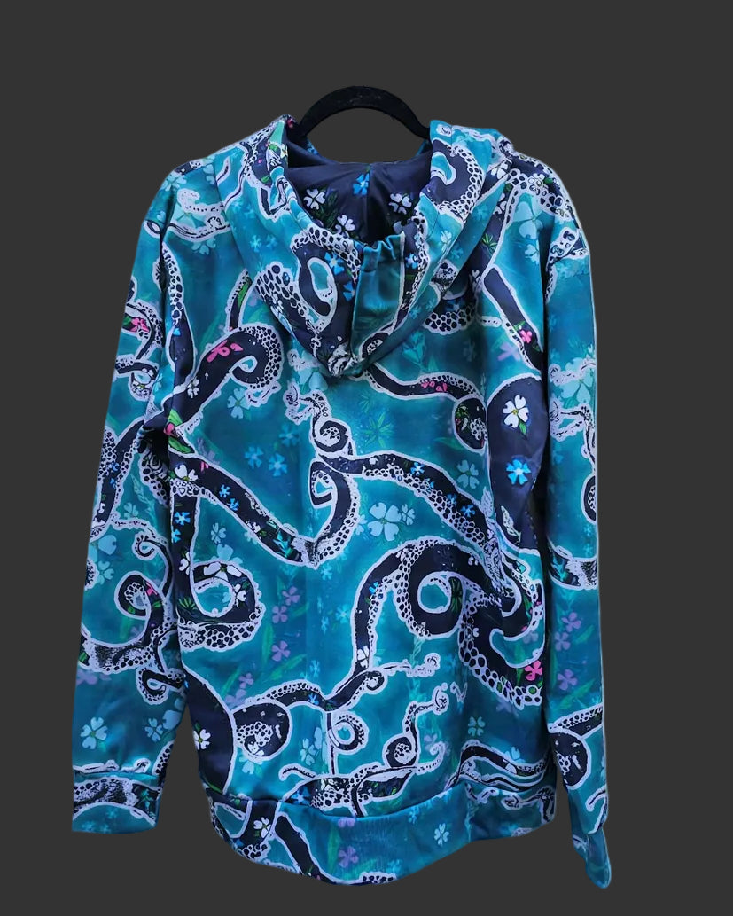 A blue and teal long-sleeve hooded sweatshirt with an octopus tentacle and floral print.